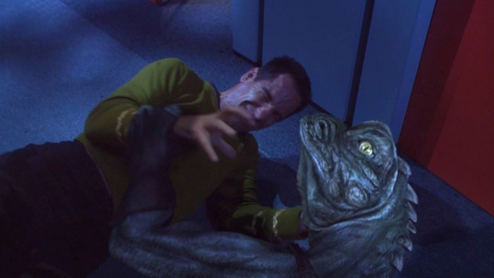 Peak Fan Service™: Archer, in a Kirk wrap-around tunic, fighting a Gorn.